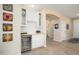 Stylish bar area with custom cabinetry, a wine fridge, and decorative shelving at 16466 W Lariat Ln, Surprise, AZ 85387