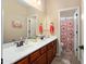 Bright bathroom featuring a double sink vanity, a large mirror and separate shower at 16466 W Lariat Ln, Surprise, AZ 85387