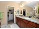 Bathroom features dual sinks, granite countertops, and walk-in closet for storage at 16466 W Lariat Ln, Surprise, AZ 85387