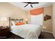Comfortable bedroom features a ceiling fan, window, and a black metal bed frame at 16466 W Lariat Ln, Surprise, AZ 85387