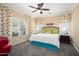 Relaxing bedroom with ceiling fan, decorative curtains and cozy carpet flooring at 16466 W Lariat Ln, Surprise, AZ 85387