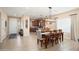 Open-concept dining area flowing into a modern kitchen and a sunlit living space at 16466 W Lariat Ln, Surprise, AZ 85387