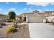 Beautiful home showcasing desert landscaping, a welcoming porch, and ample parking space at 16466 W Lariat Ln, Surprise, AZ 85387