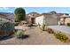 Charming single-story home featuring desert landscaping, a two-car garage, and a cozy front porch at 16466 W Lariat Ln, Surprise, AZ 85387