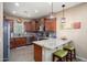 Well-lit kitchen features stainless appliances, granite counters, and stylish pendant lighting at 16466 W Lariat Ln, Surprise, AZ 85387