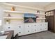 Stylish living room features custom built-ins, floating shelves, and a modern design at 16466 W Lariat Ln, Surprise, AZ 85387