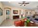 Cozy living space with TV, mini bar and open layout to the dining and kitchen area at 16466 W Lariat Ln, Surprise, AZ 85387