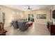 Inviting living room with wood floors, ceiling fan and sliding doors to backyard at 16466 W Lariat Ln, Surprise, AZ 85387