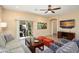Comfortable living room featuring ceiling fan, sliding glass doors, and modern decor at 16466 W Lariat Ln, Surprise, AZ 85387