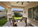 Inviting covered patio featuring comfortable seating and a view of the landscaped backyard at 16466 W Lariat Ln, Surprise, AZ 85387