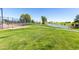 Beautiful community green space with a pond, trees, tennis court and walking paths at 17200 W Bell Rd # 1202, Surprise, AZ 85374