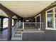Inviting covered patio with white railings, tiled floors, neutral paint, and a bright white ceiling at 17200 W Bell Rd # 1202, Surprise, AZ 85374