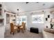 Bright dining area with a glass table, wicker chairs, and charming details at 17200 W Bell Rd # 1202, Surprise, AZ 85374