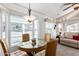 Bright dining area with glass table and wicker chairs, adjacent to living area at 17200 W Bell Rd # 1202, Surprise, AZ 85374