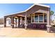 Cozy home featuring a covered carport, front porch area, and picturesque windows at 17200 W Bell Rd # 1202, Surprise, AZ 85374