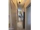 Hallway view leading to the kitchen, showcasing appliances and cabinet space at 17200 W Bell Rd # 1202, Surprise, AZ 85374