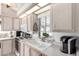 Well-lit kitchen featuring white countertops, appliances, and a window above the sink at 17200 W Bell Rd # 1202, Surprise, AZ 85374