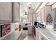 Open-concept kitchen with neutral cabinets, modern appliances, and a view of the living area at 17200 W Bell Rd # 1202, Surprise, AZ 85374