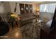 Cozy living room features a beige sofa, decorative mirrors, and a tropical themed rug at 17200 W Bell Rd # 1202, Surprise, AZ 85374