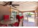 Inviting outdoor space features a table, chairs, and ceiling fan at 17200 W Bell Rd # 1202, Surprise, AZ 85374