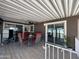 A covered patio seating area with an outdoor table, chairs, and a ceiling fan at 17200 W Bell Rd # 1202, Surprise, AZ 85374
