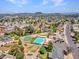 Panoramic aerial shot showcasing a vibrant residential community with green spaces, sports areas, and mountain views at 17838 N 45Th Ave, Glendale, AZ 85308