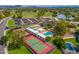 A scenic aerial view of the community tennis courts and pools surrounded by mature landscaping and cityscapes at 17838 N 45Th Ave, Glendale, AZ 85308