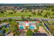 A scenic aerial view of the community showcasing the tennis courts, pools, and meticulously maintained landscaping at 17838 N 45Th Ave, Glendale, AZ 85308