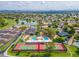 An aerial view of the community tennis courts and pools surrounded by mature landscaping and cityscapes at 17838 N 45Th Ave, Glendale, AZ 85308
