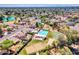 An expansive aerial view of the community featuring swimming pool, sports courts, and tree-lined streets at 17838 N 45Th Ave, Glendale, AZ 85308