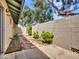 Private backyard area featuring a block wall, stone pathway, lush green shrubbery and mature trees at 17838 N 45Th Ave, Glendale, AZ 85308