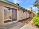 Back exterior of home featuring a sliding glass door, manicured landscaping, and a fenced patio area at 17838 N 45Th Ave, Glendale, AZ 85308