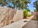 Wide shot of the backyard showing desert landscaping with block wall, mature tree and concrete patio at 17838 N 45Th Ave, Glendale, AZ 85308