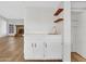 Wet bar with white cabinets and countertop and wood shelves by the sink at 17838 N 45Th Ave, Glendale, AZ 85308