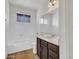 Bright bathroom featuring tiled walls, modern vanity with solid surface countertops, and a tub with shower at 17838 N 45Th Ave, Glendale, AZ 85308
