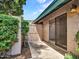 Private patio featuring a sliding glass door, block wall, and lush greenery, perfect for relaxing or entertaining at 17838 N 45Th Ave, Glendale, AZ 85308