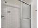 Shower with white tiled walls and sliding glass doors at 17838 N 45Th Ave, Glendale, AZ 85308