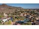 Beautiful aerial view of resort-style amenities including a pool, tennis courts, and lush landscaping, set against a mountain backdrop at 1808 E Hayward Ave # 1, Phoenix, AZ 85020