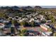 Overhead view showcasing community tennis courts and neighborhood homes nestled amongst mature trees and desert landscape at 1808 E Hayward Ave # 1, Phoenix, AZ 85020