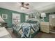Bright bedroom features a ceiling fan and decorative bedding at 1808 E Hayward Ave # 1, Phoenix, AZ 85020