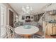 Open-concept dining area with a view of the living room and a modern chandelier at 1808 E Hayward Ave # 1, Phoenix, AZ 85020
