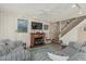 Comfortable living room with a fireplace, TV, patterned sofas, and staircase access at 1808 E Hayward Ave # 1, Phoenix, AZ 85020