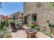 This outdoor patio features a dining table, colorful flowers, and a unique modern fire pit at 1808 E Hayward Ave # 1, Phoenix, AZ 85020