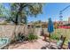 Quaint brick patio featuring a vibrant garden, comfortable seating, and stucco wall at 1808 E Hayward Ave # 1, Phoenix, AZ 85020