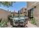 Relaxing outdoor patio featuring a dining table and vibrant flower decor at 1808 E Hayward Ave # 1, Phoenix, AZ 85020