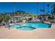 Community pool and spa with lounge chairs and a pergola-covered seating area at 1808 E Hayward Ave # 1, Phoenix, AZ 85020