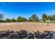 Community sand volleyball court with net and trees, perfect for outdoor recreation and activities at 1808 E Hayward Ave # 1, Phoenix, AZ 85020