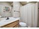 Well-lit bathroom with a single sink vanity, neutral color scheme, and shower with a curtain at 19115 E Buckskin Ct, Rio Verde, AZ 85263