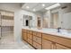 Bright bathroom featuring a dual sink vanity, large mirror, and walk-in closet at 19115 E Buckskin Ct, Rio Verde, AZ 85263