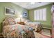 Charming bedroom showcasing twin beds with colorful floral bedding and soft green walls at 19115 E Buckskin Ct, Rio Verde, AZ 85263